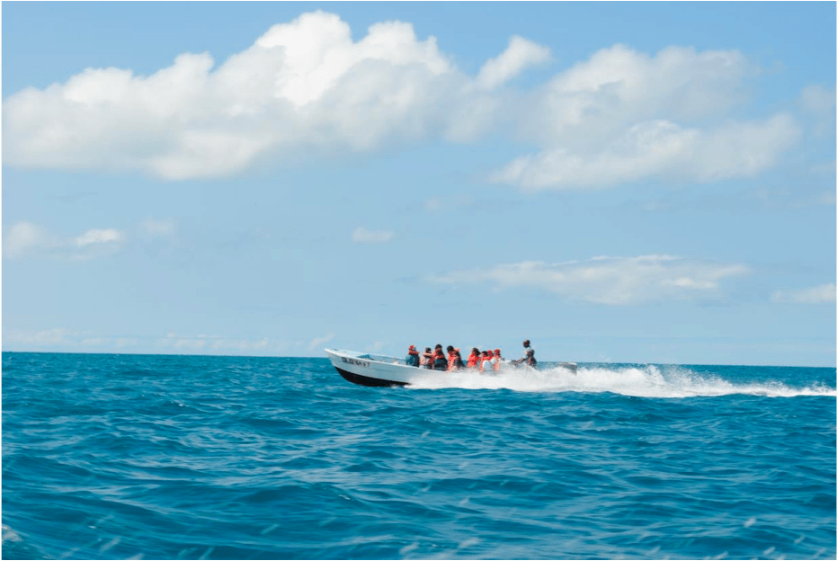 Boating to explore snorkeling spots around the reef, Belize